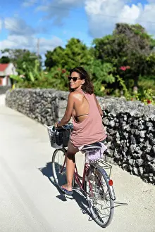 Bicycle Prints: Young woman rides bike in Taketomi Island, Okinawa Prefecture, Japan