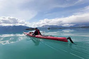 Physical Fitness Prints: Young woman in a sea kayak, paddling