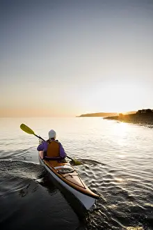 Paddle Prints: Young woman sea kayaking in Kachemak Bay