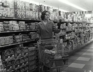 Cart Prints: Young woman with a shopping cart in a grocery store