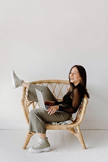 Middle Eastern Prints: Young woman sitting in chair with laptop