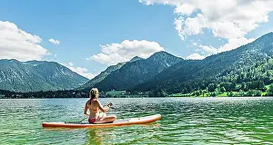 Paddle Prints: Young woman sitting on a Standup-Paddle Board or SUP