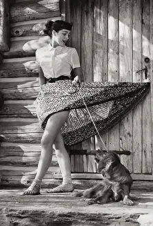 One Young Woman Only Prints: Young woman standing in front of her house with her dog