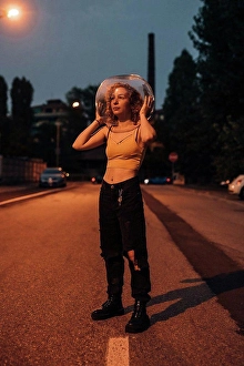 Protective Sportswear Prints: Young woman standing on street with glass bowl on her head