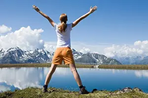 Hike Prints: Young woman stretching back in the mountains
