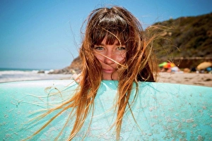 Only One Prints: Young woman with surfboard