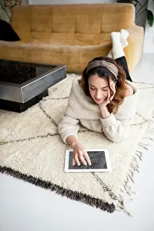 Cyberspace Prints: Young woman using digital tablet at home