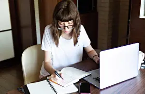 Case Prints: Young woman using laptop at table