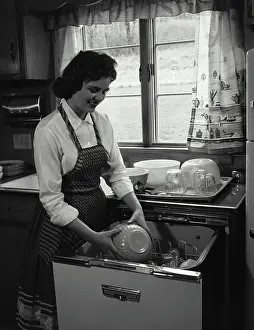 Kitchen Appliance Prints: Young woman working in a kitchen