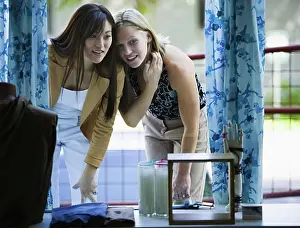 Doors Prints: Two young women looking at a window display